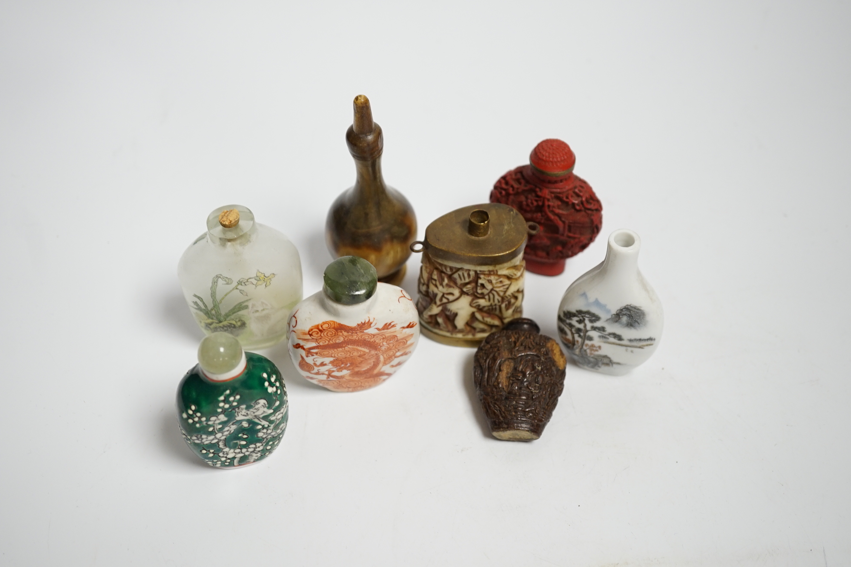 Seven various Chinese snuff bottles including horn, simulated lacquer, porcelain, glass, wood and a small bone powder flask
